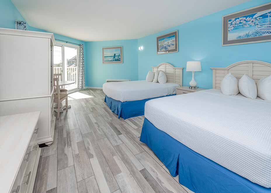 inside a long beach island hotel room with two beds