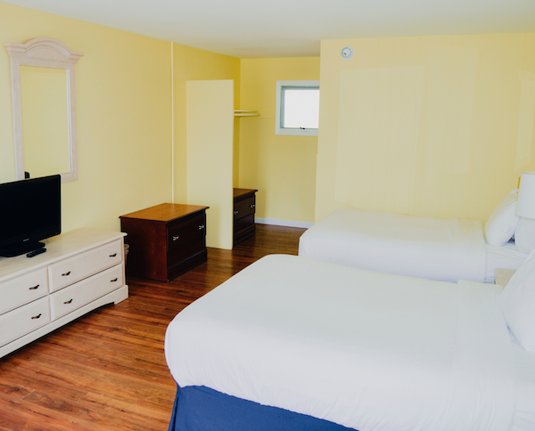 a room with two beds and a tv