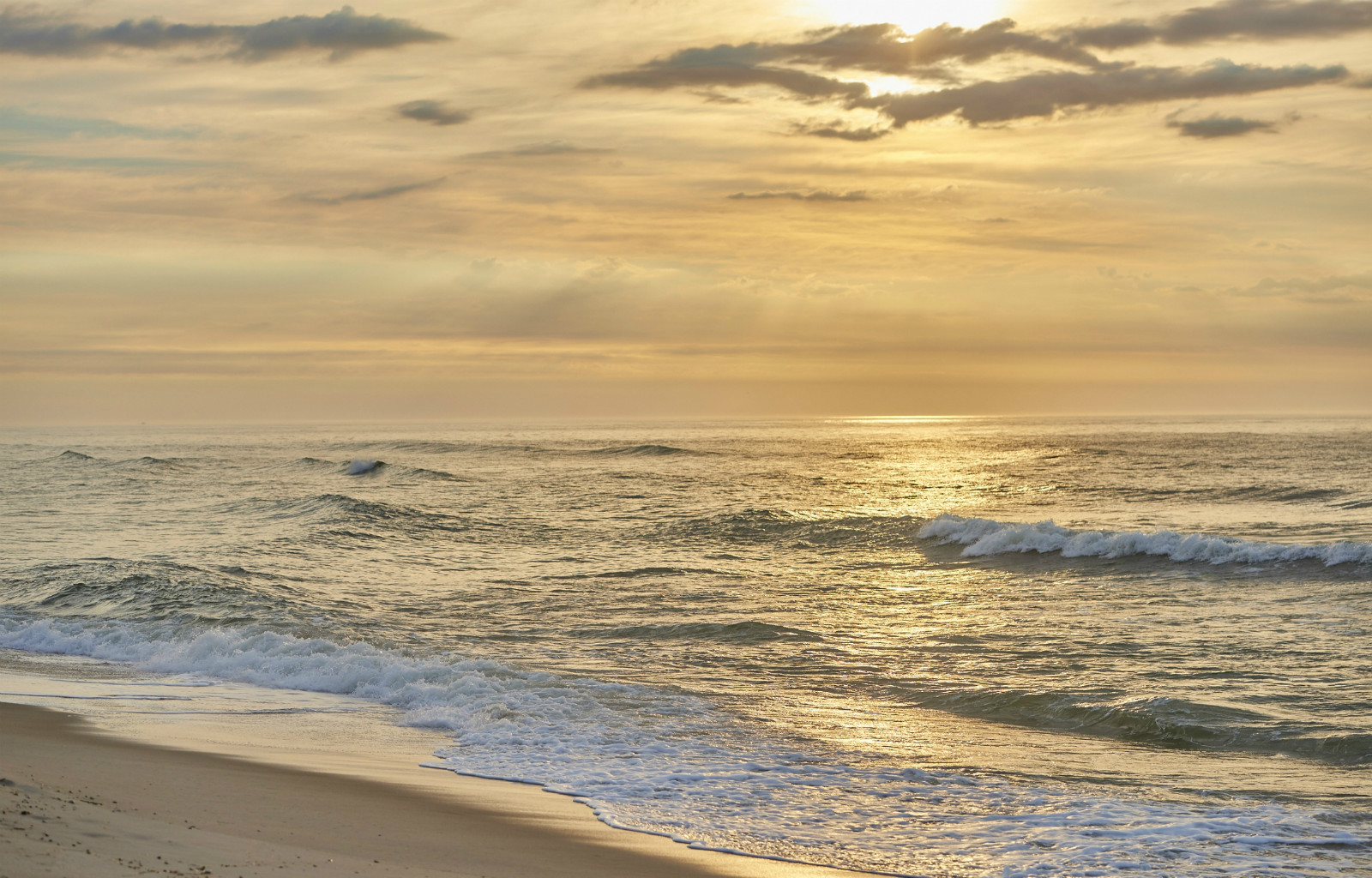 Golden sunset over the Atlantic Ocean at Long Beach Island hotel beach | Drifting Sands LBI